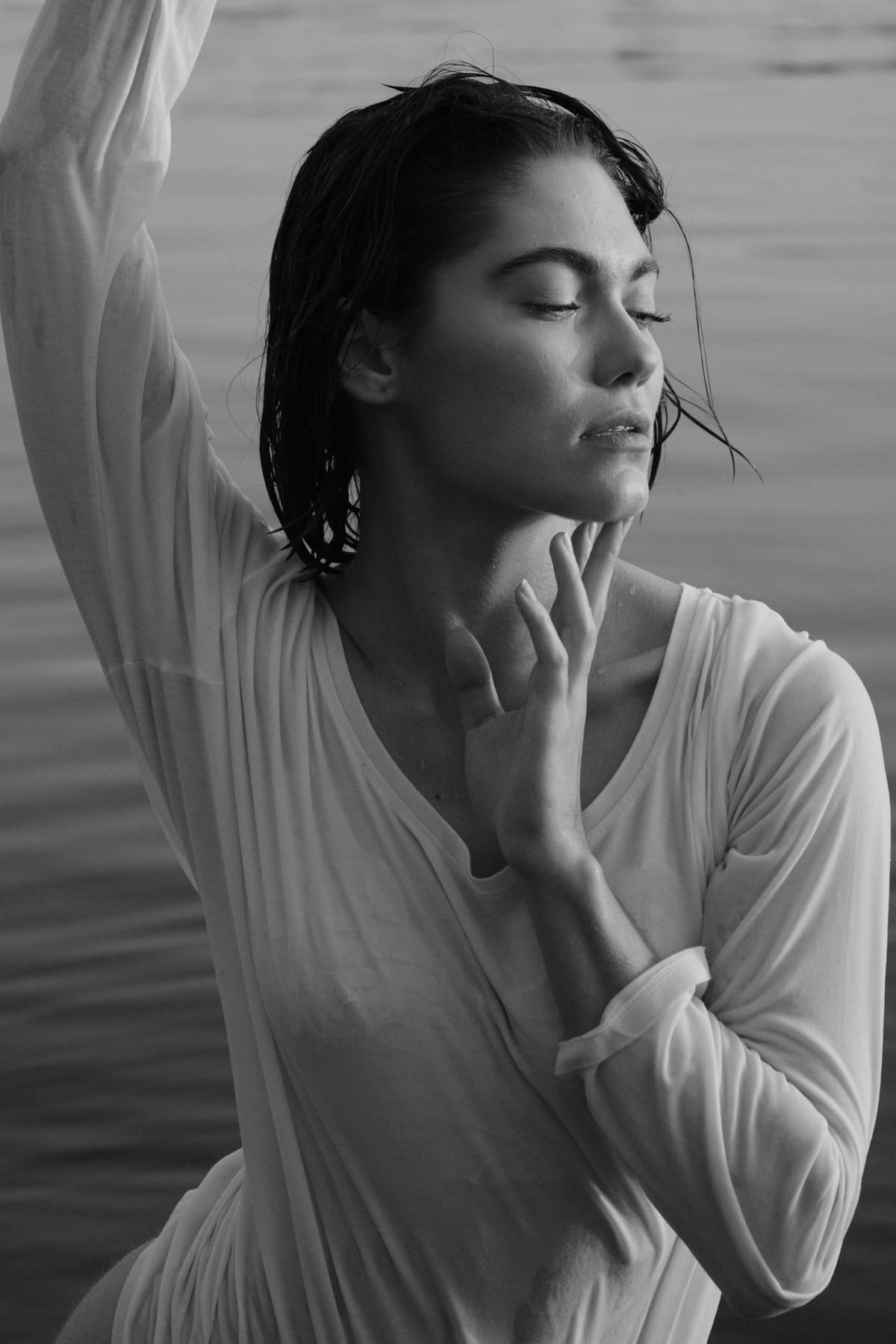 Portrait by water in a white shirt